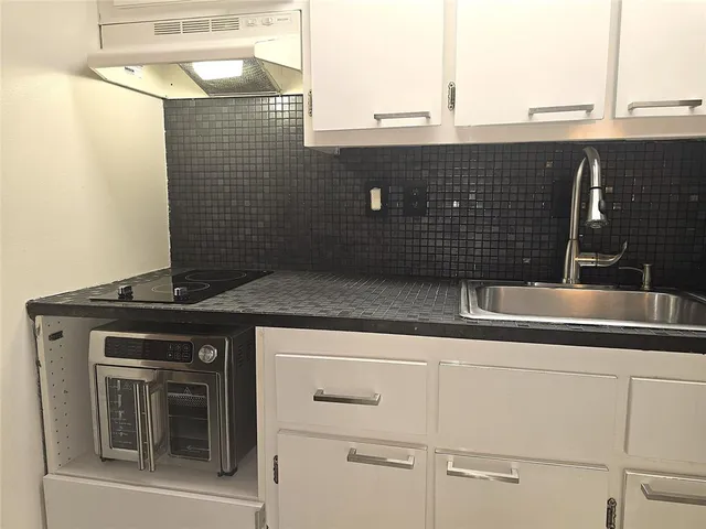 a kitchen with a sink and a refrigerator
