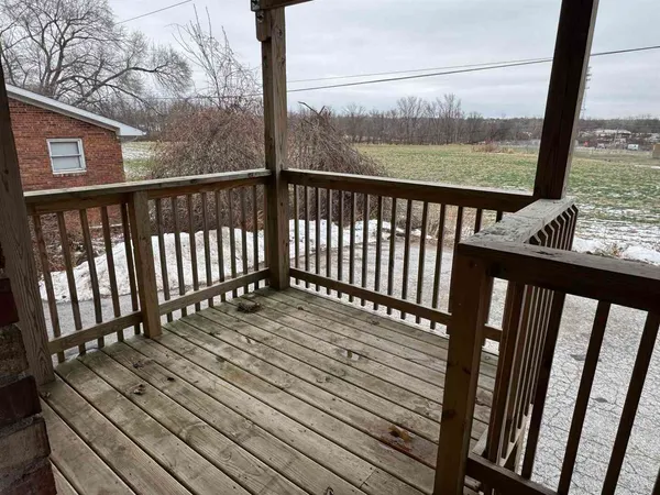 a view of balcony with wooden floor