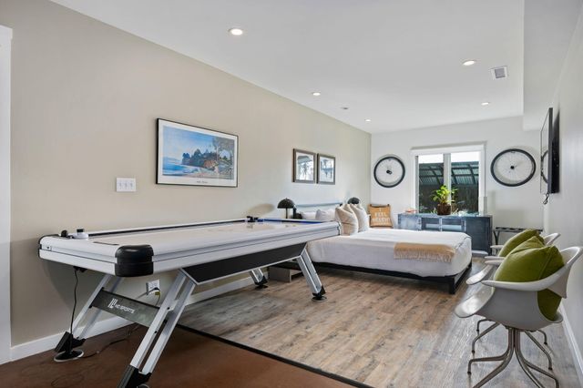 a bedroom with a bed a mirror and a window