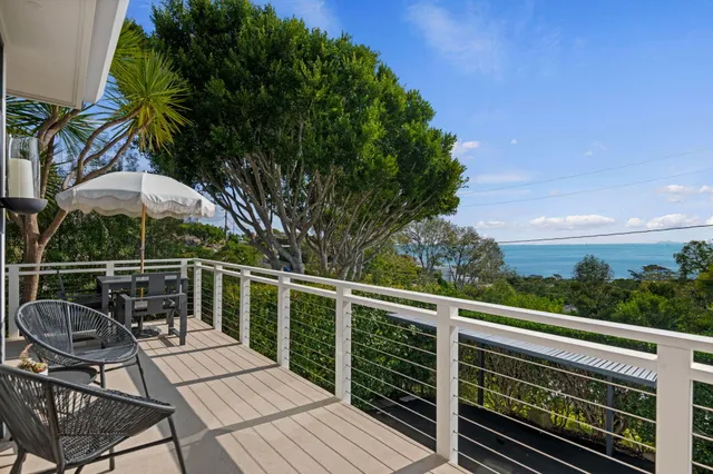 a view of a dining table and chairs in the balcony