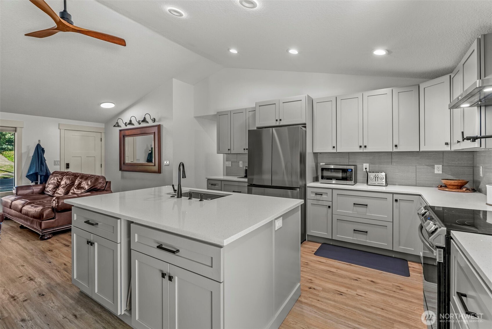 3167 Pacific Way Longview, WA 98632 - Photo 12 of 39 a kitchen that has a lot of cabinets in it and wooden floors