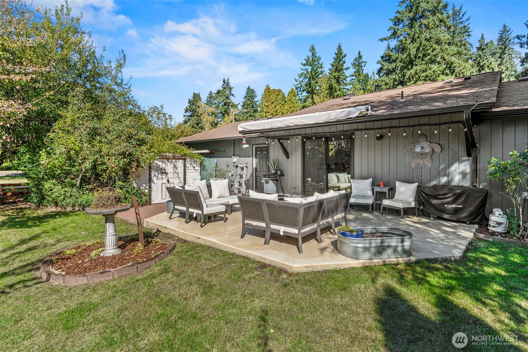 3167 Pacific Way Longview, WA 98632 - Photo 30 of 39 a view of a patio with table and chairs and potted plants with large tree