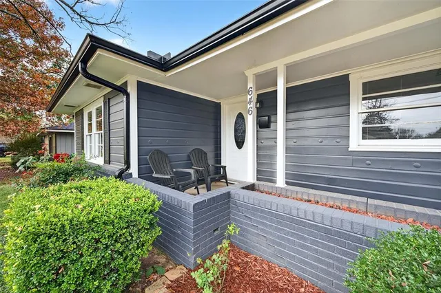 a view of a house with couches chair and glass door