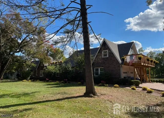 a view of a lake with a table and chairs under an umbrella