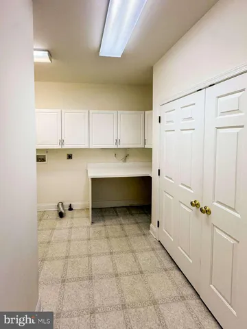 a view of a kitchen with white cabinets