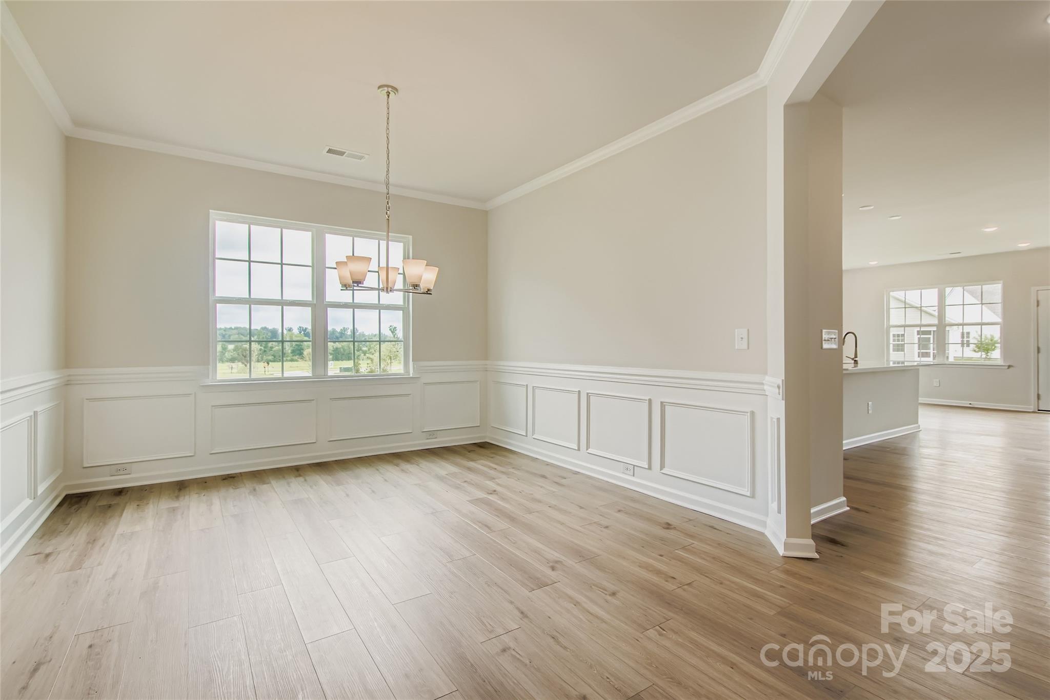 2803 Morning Song Way Lancaster, SC 29720 - Photo 5 of 18 an empty room with wooden floor and windows