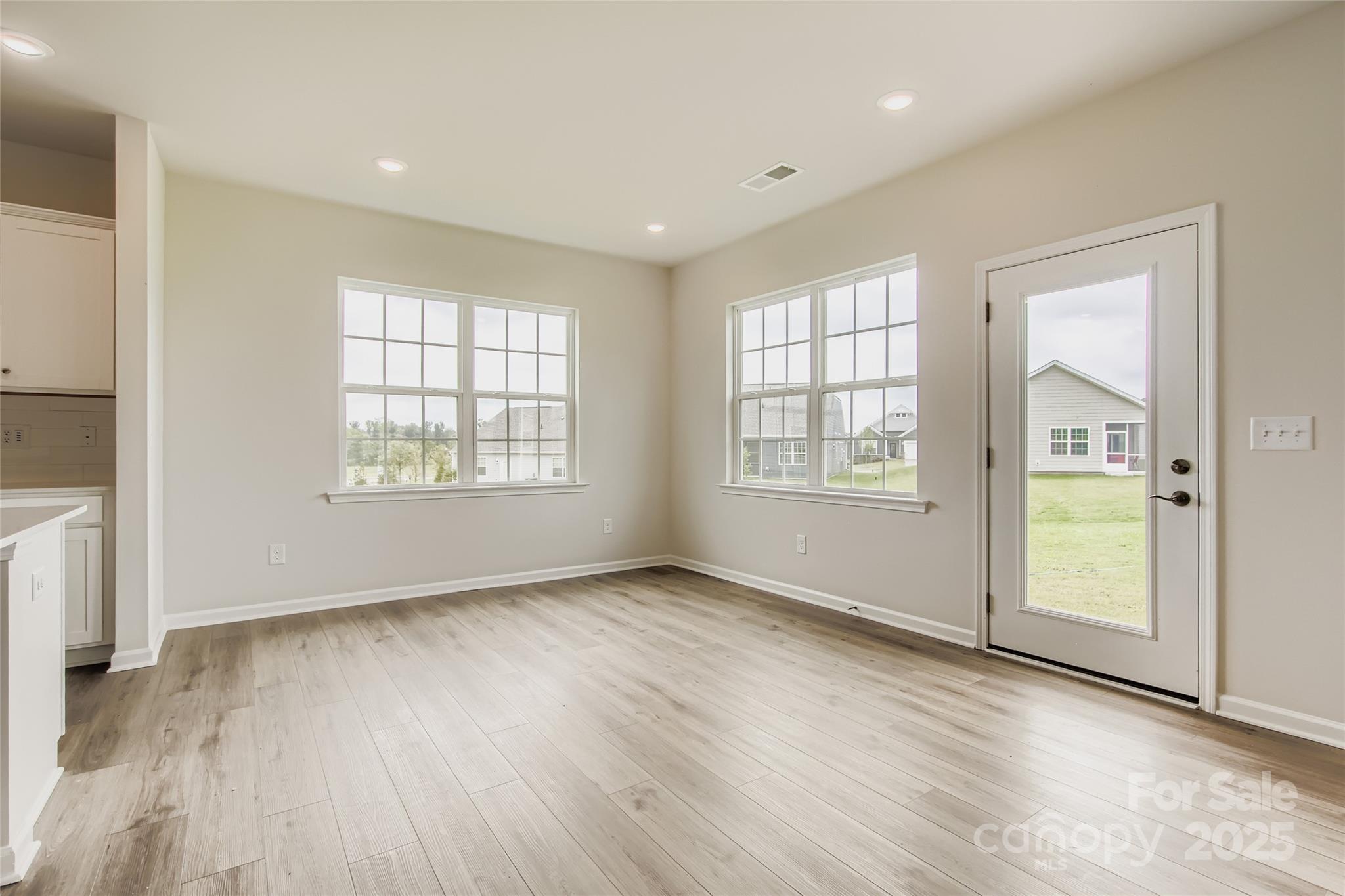 2803 Morning Song Way Lancaster, SC 29720 - Photo 7 of 18 an empty room with wooden floor and windows