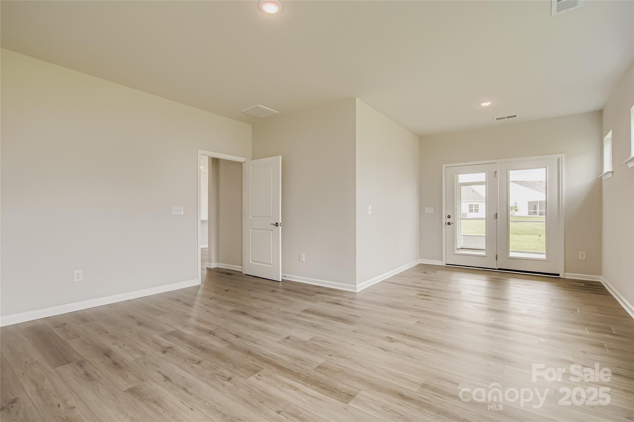 2803 Morning Song Way Lancaster, SC 29720 - Photo 8 of 18 a view of an empty room with window and wooden floor