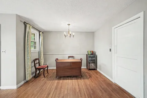 a view of a livingroom with furniture and an empty room