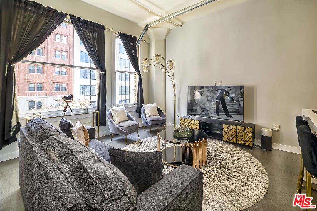 939 South Broadway, Unit 304 Los Angeles, CA 90015 - Photo 15 of 21 a living room with furniture and a large window