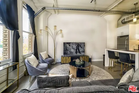 a view of a living room and kitchen