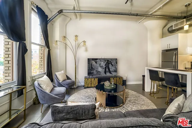 a view of a living room and kitchen