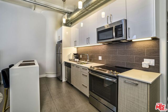 a kitchen with a stove and a microwave