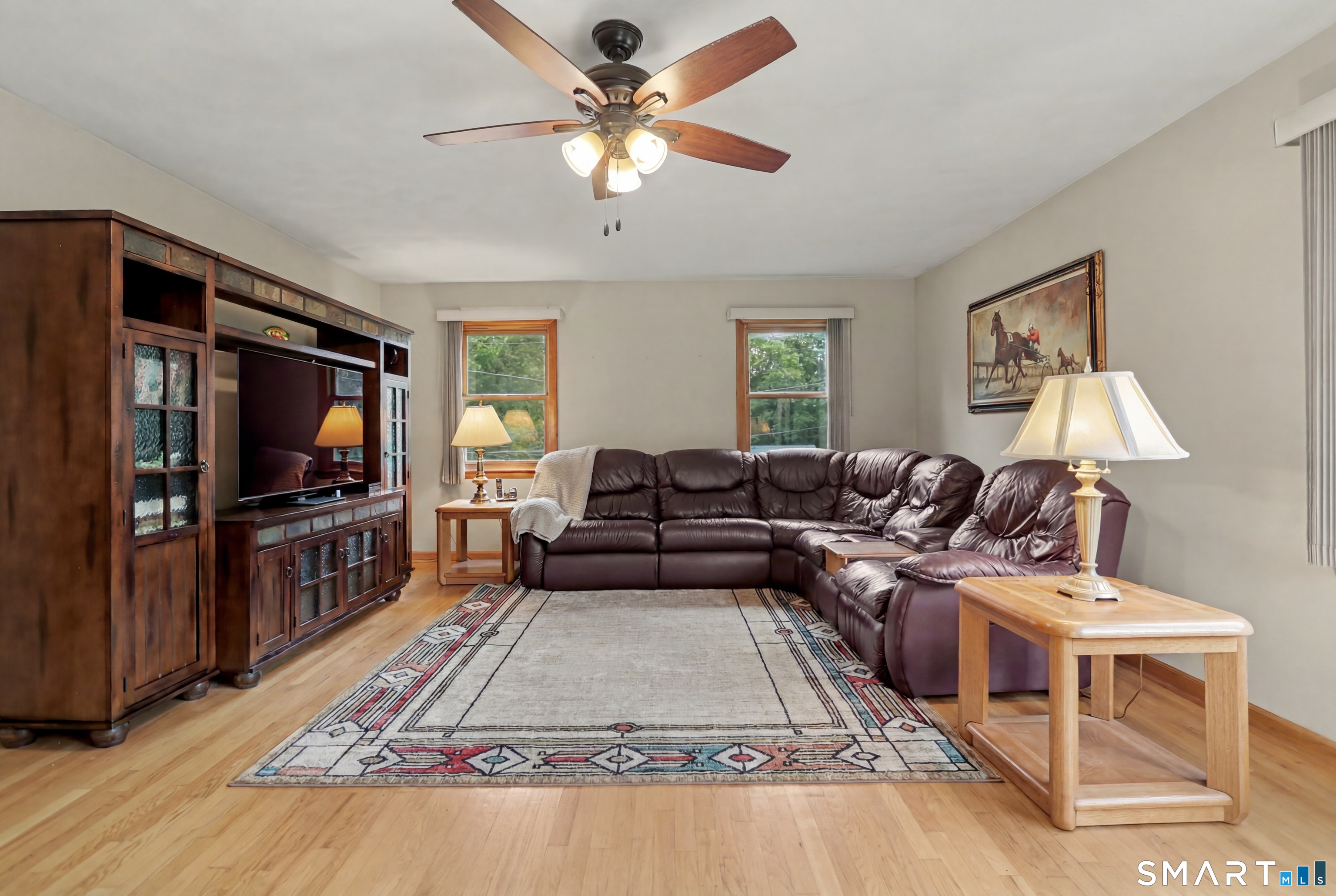 632 Wheelers Farm Road Orange, CT 06477 - Photo 13 of 39 a living room with furniture and a flat screen tv