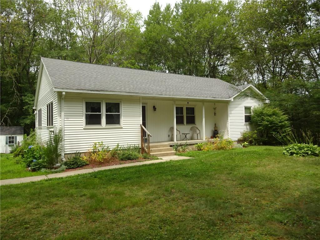 a front view of house with yard and green space