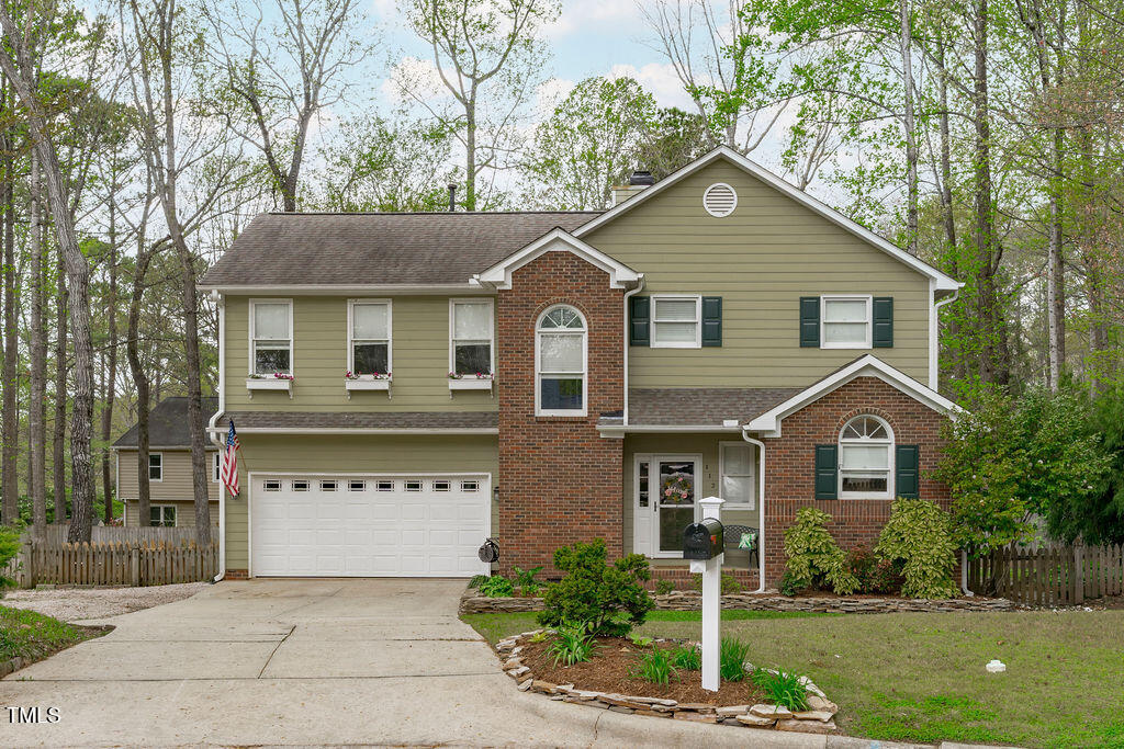 112 Oxpens Road Cary, NC 27513 - Photo 1 of 37 a front view of a house with a yard and garage
