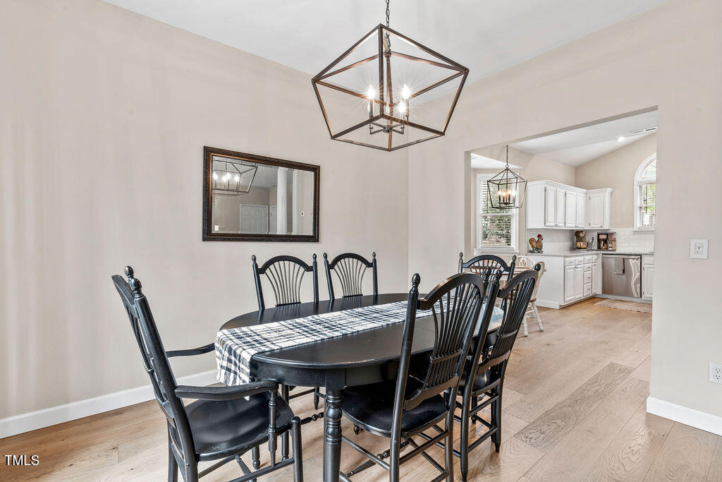 112 Oxpens Road Cary, NC 27513 - Photo 12 of 37 a view of a a dining room with furniture window and wooden floor
