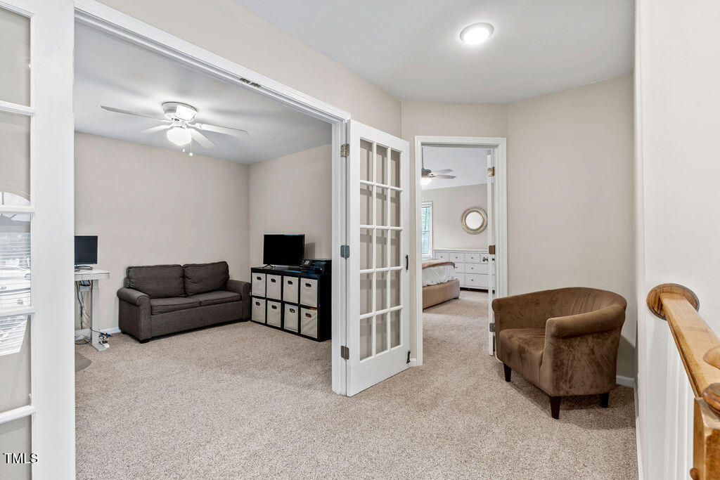 112 Oxpens Road Cary, NC 27513 - Photo 21 of 37 a living room with furniture a ceiling fan and a rug