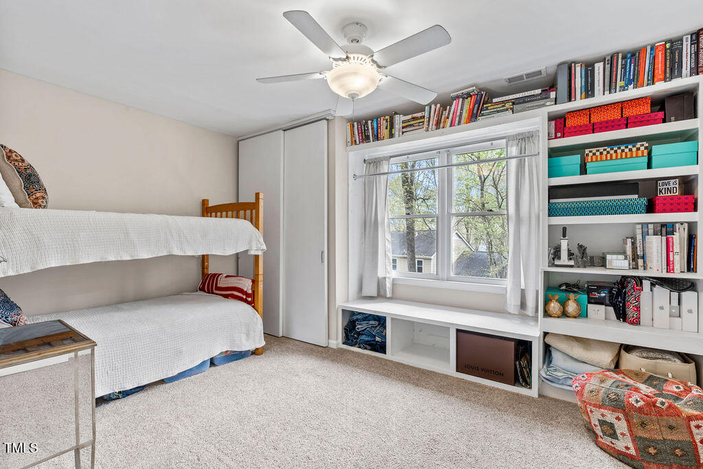 112 Oxpens Road Cary, NC 27513 - Photo 27 of 37 a bedroom with furniture and a book shelf