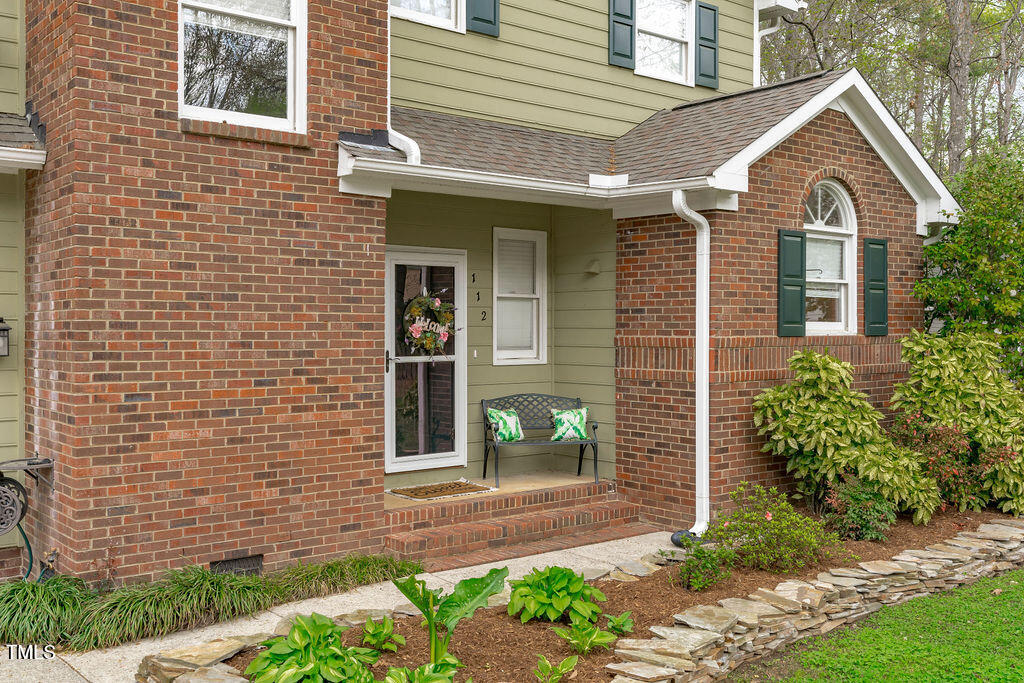 112 Oxpens Road Cary, NC 27513 - Photo 3 of 37 a view of a brick house with many windows