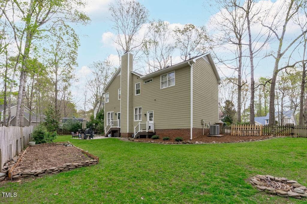 112 Oxpens Road Cary, NC 27513 - Photo 32 of 37 a backyard of a house with lots of green space