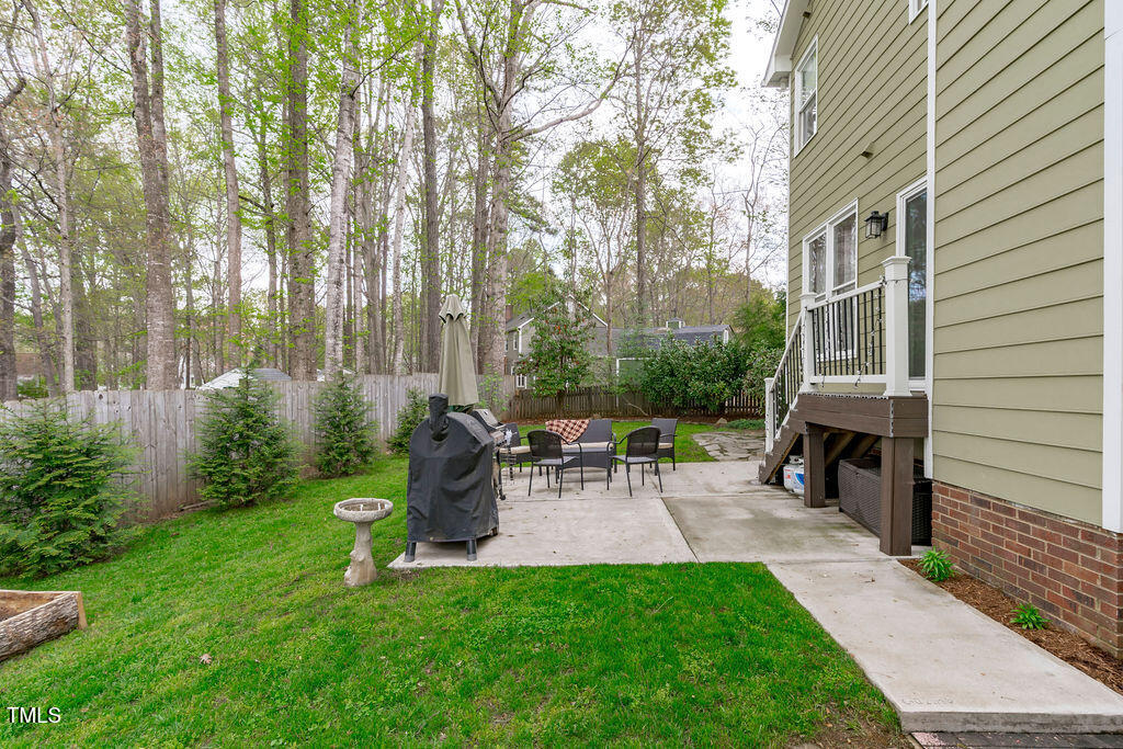 112 Oxpens Road Cary, NC 27513 - Photo 34 of 37 a view of backyard with table and chairs and a large tree
