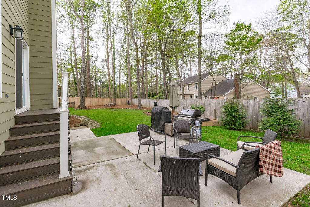112 Oxpens Road Cary, NC 27513 - Photo 35 of 37 a view of a patio with couches table and chairs and garden