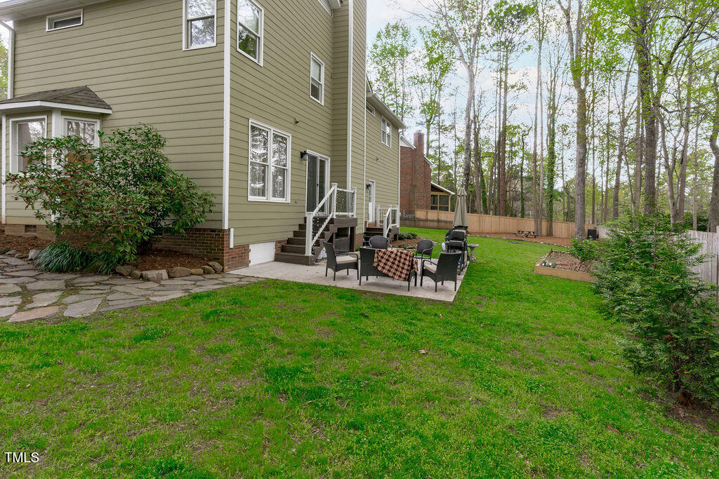 112 Oxpens Road Cary, NC 27513 - Photo 37 of 37 a view of a chair and table in backyard of the house