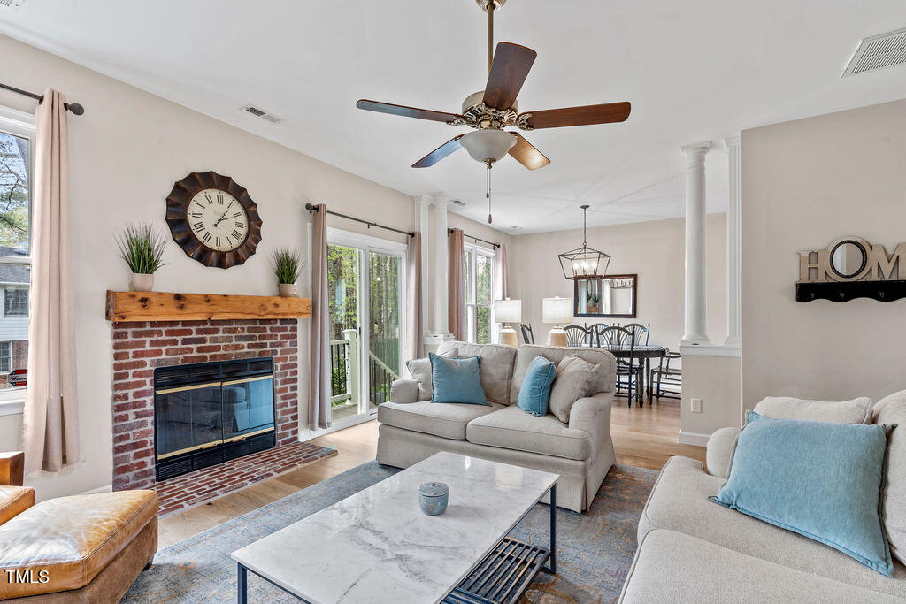112 Oxpens Road Cary, NC 27513 - Photo 6 of 37 a living room with furniture a clock and a fireplace