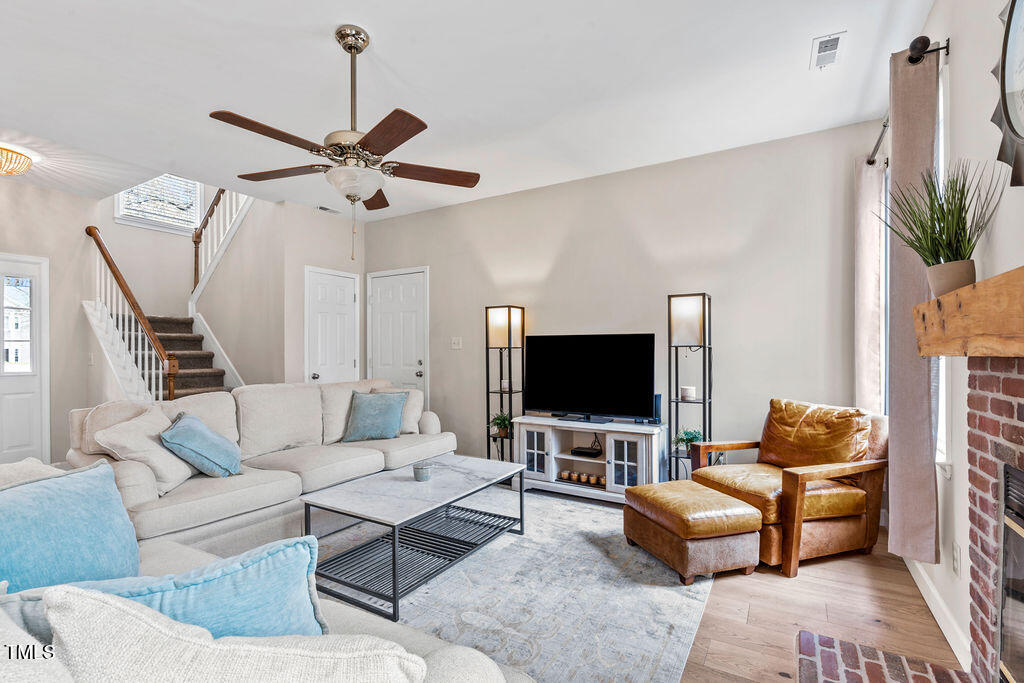 112 Oxpens Road Cary, NC 27513 - Photo 8 of 37 a living room with furniture a ceiling fan and a flat screen tv