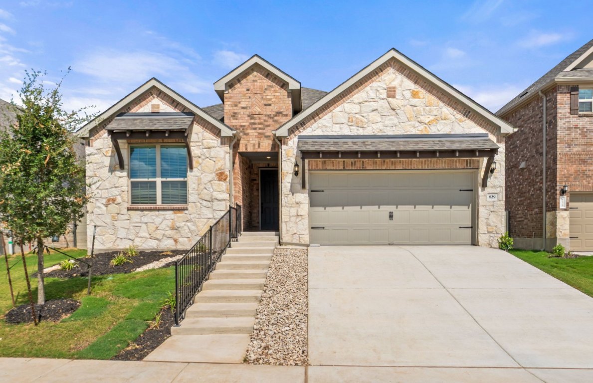 829 Round Mountain Pass Georgetown, TX 78628 - Photo 1 of 17 a front view of a house with a yard and garage