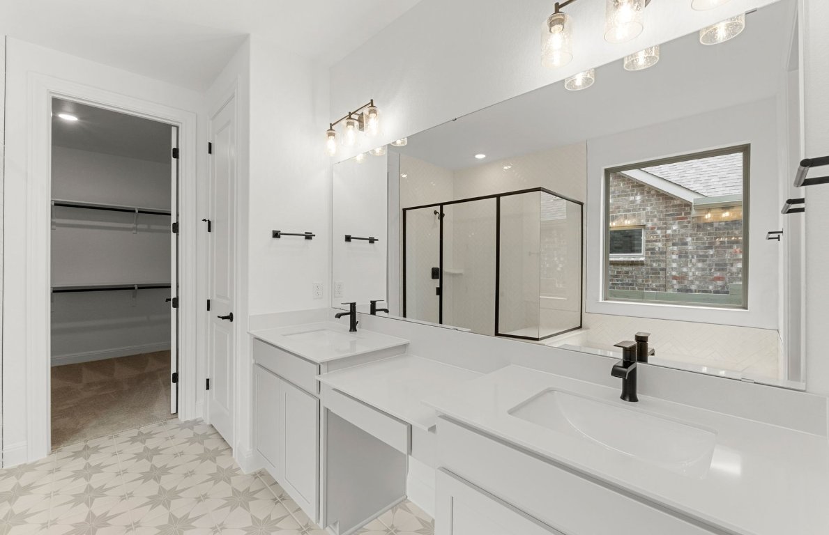 829 Round Mountain Pass Georgetown, TX 78628 - Photo 12 of 17 a bathroom with a sink vanity and a mirror