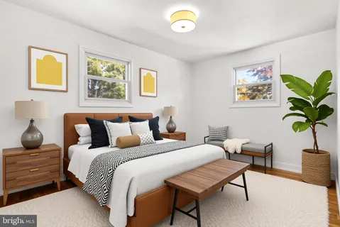 a bedroom with furniture and a potted plant