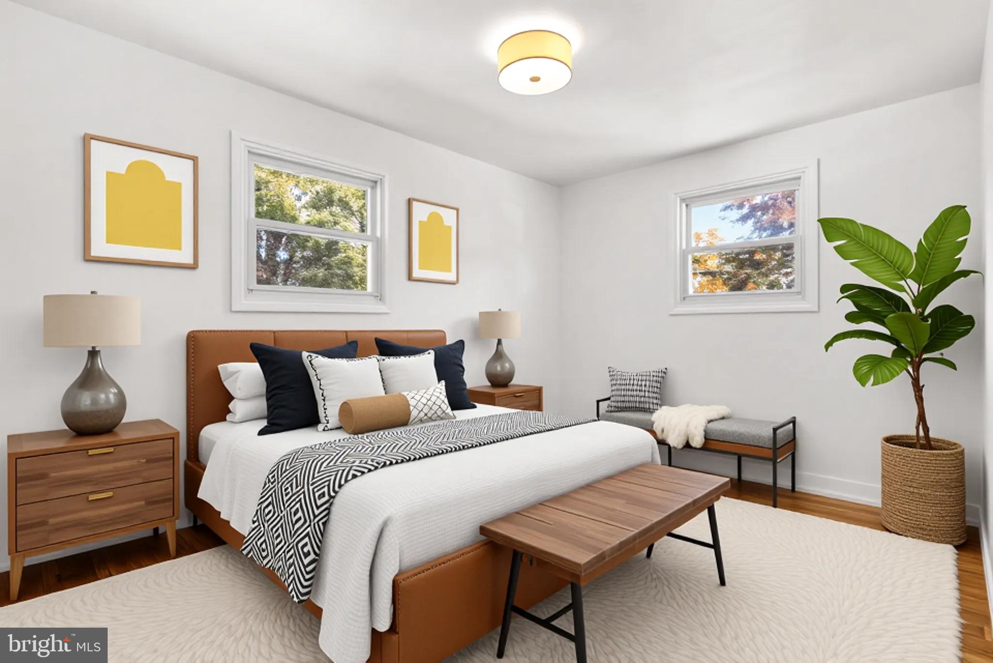 8700 50th Place College Park, MD 20740 - Photo 12 of 33 a bedroom with furniture and a potted plant