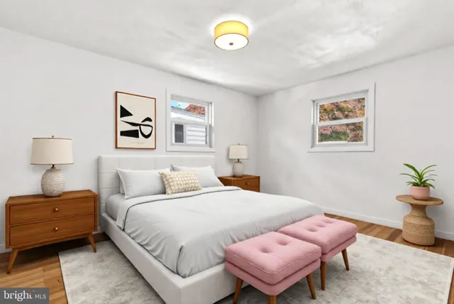 a bedroom with a bed and a painting on the wall