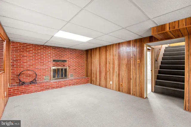 a view of an empty room with a fireplace