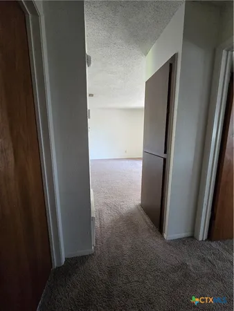 an empty room with closet and mirror