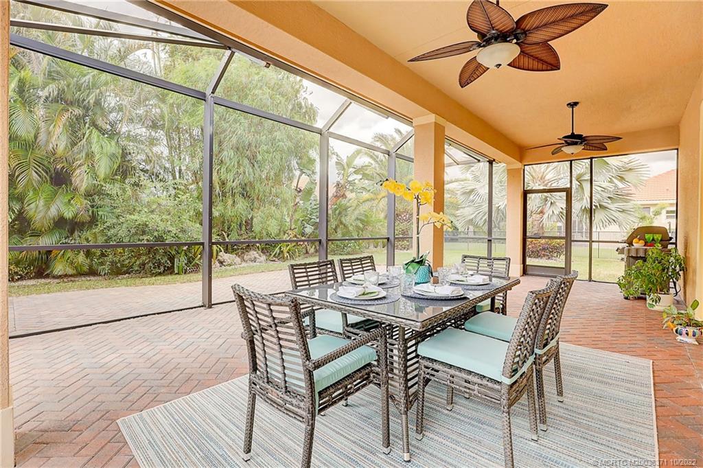 7426 Southeast Laque Circle Stuart, FL 34997 - Photo 19 of 81 a dining room with furniture water view and a floor to ceiling window