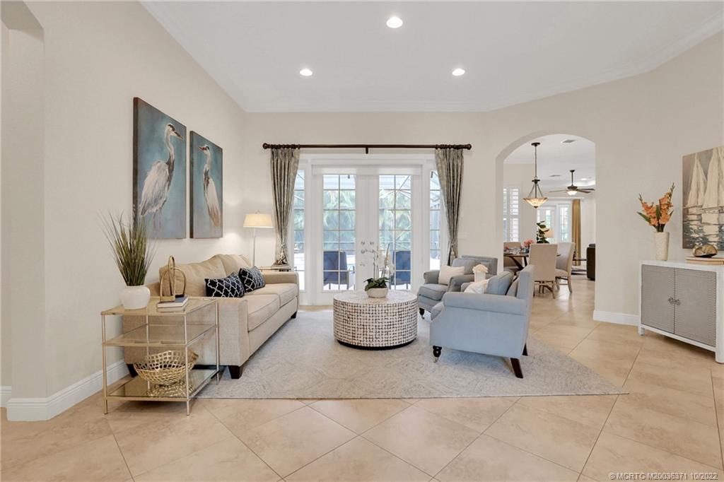 7426 Southeast Laque Circle Stuart, FL 34997 - Photo 22 of 81 a living room with fireplace furniture and a large window