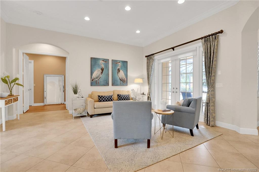 7426 Southeast Laque Circle Stuart, FL 34997 - Photo 27 of 81 a living room with furniture and a large window