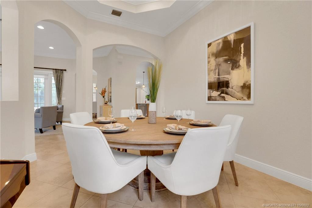 7426 Southeast Laque Circle Stuart, FL 34997 - Photo 32 of 81 a view of a dining room with furniture and wooden floor
