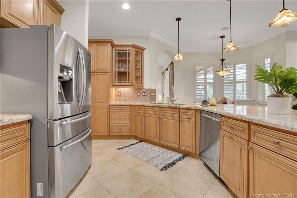 7426 Southeast Laque Circle Stuart, FL 34997 - Photo 38 of 81 a kitchen with stainless steel appliances granite countertop a refrigerator a sink a stove and oven