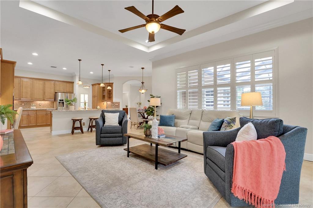 7426 Southeast Laque Circle Stuart, FL 34997 - Photo 44 of 81 a living room with furniture and a large window