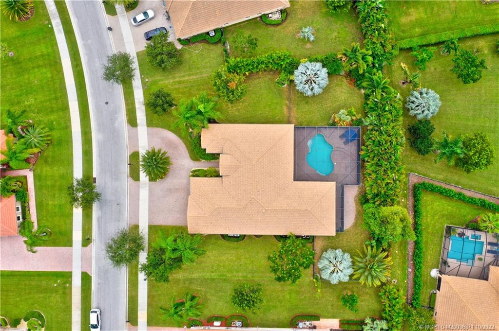 7426 Southeast Laque Circle Stuart, FL 34997 - Photo 5 of 81 an aerial view of a house with a yard basket ball court and outdoor seating