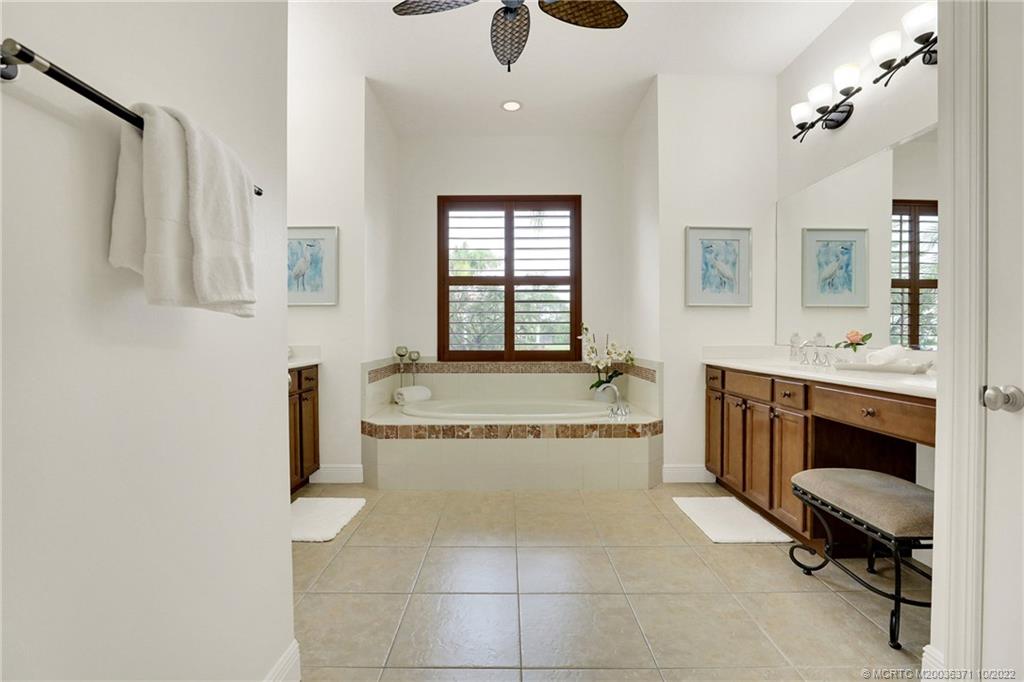 7426 Southeast Laque Circle Stuart, FL 34997 - Photo 56 of 81 a spacious bathroom with a tub a sink and mirror