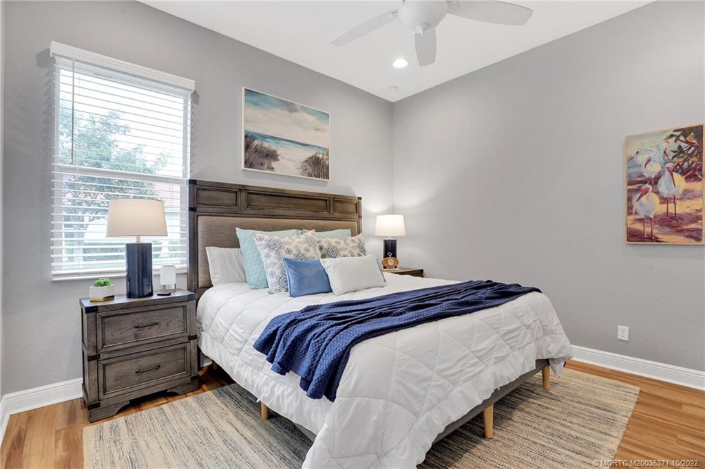 7426 Southeast Laque Circle Stuart, FL 34997 - Photo 60 of 81 a bedroom with a bed and a night stand