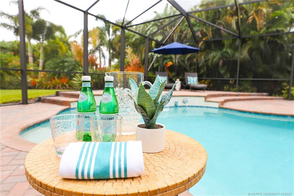 7426 Southeast Laque Circle Stuart, FL 34997 - Photo 7 of 81 a view of a swimming pool with a patio