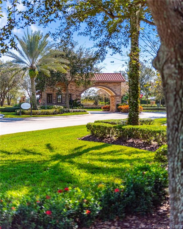 7426 Southeast Laque Circle Stuart, FL 34997 - Photo 78 of 81 a view of a house with a big yard and large trees