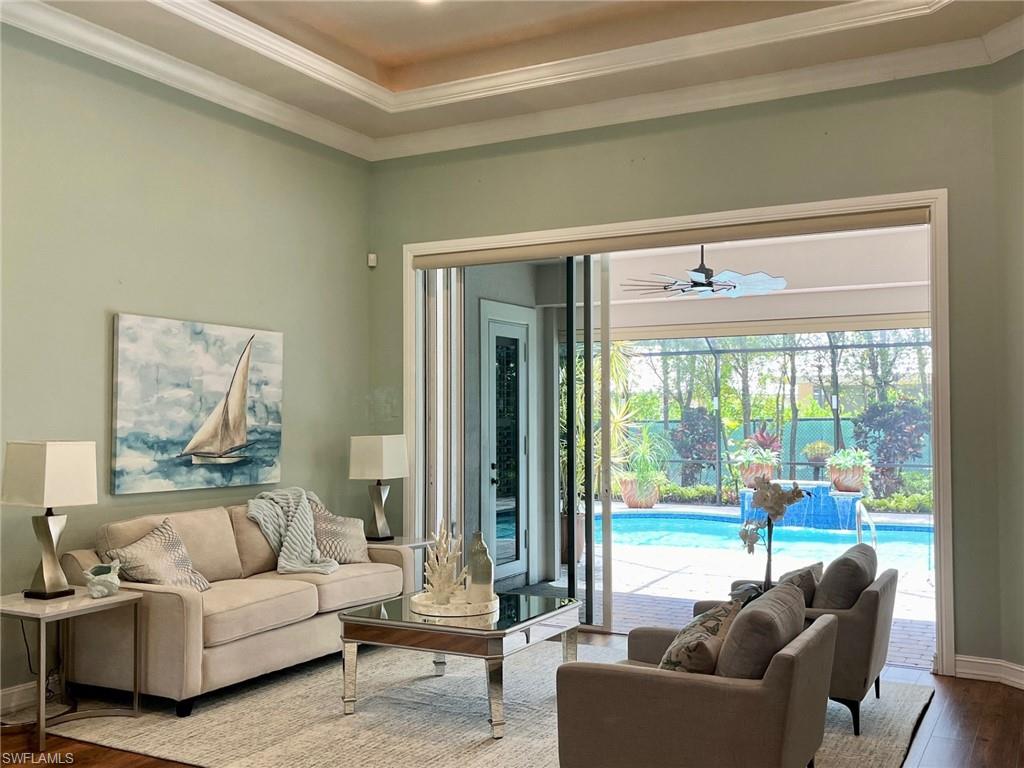 4956 Rustic Oaks Circle Naples, FL 34105 - Photo 12 of 37 a living room with furniture and a large window
