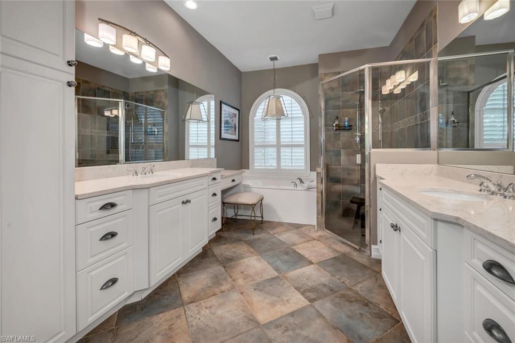 4956 Rustic Oaks Circle Naples, FL 34105 - Photo 14 of 37 a spacious bathroom with a double vanity sink a mirror and a shower